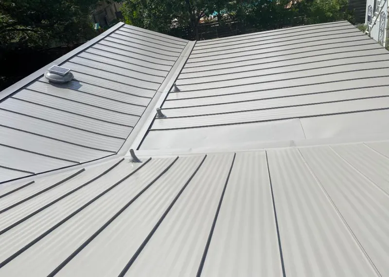 Solar attic fan installed on a metal roof for Roof Ventilation in Iowa City